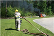 Firefigher Fighting Propane Fire with Hose