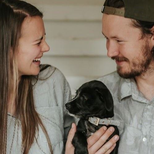 woman kisses her pet dog
