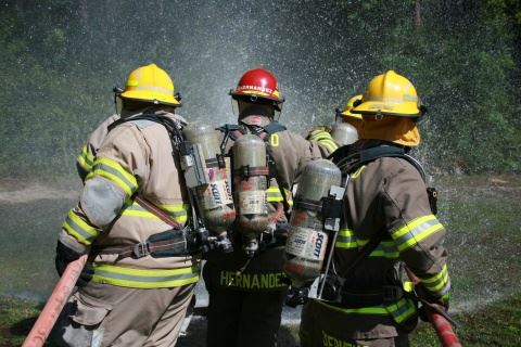 Three Firefighters Spraying Water