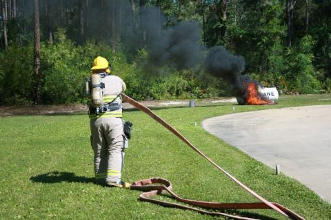 Firefigher Fighting Propane Fire with Hose